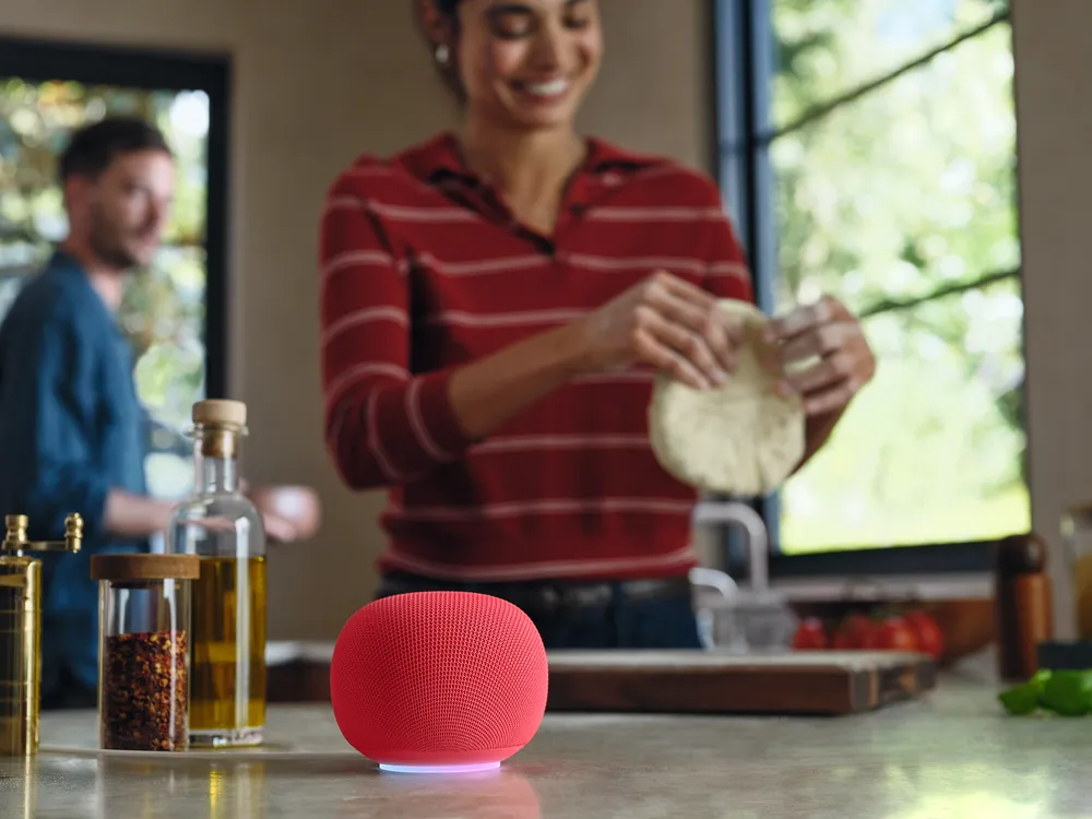 Google Home-høyttaler i fargen Jade på en stabel bøker
